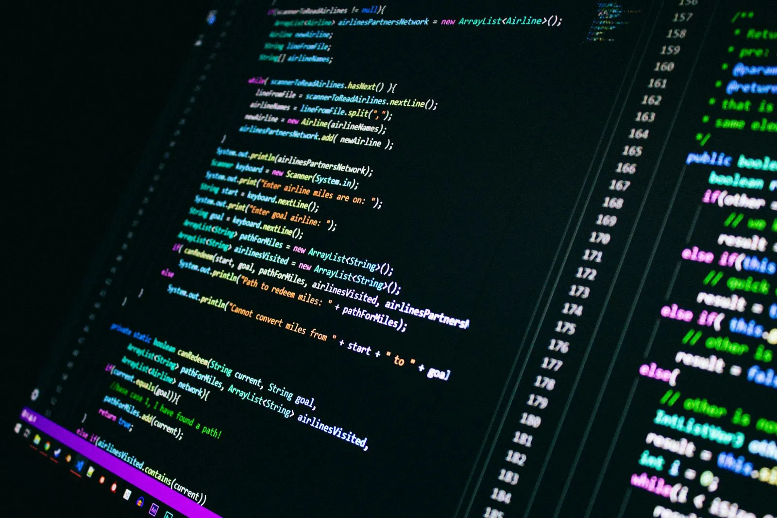 Close-up of a monitor showing Java code for an airline-miles pathfinding program