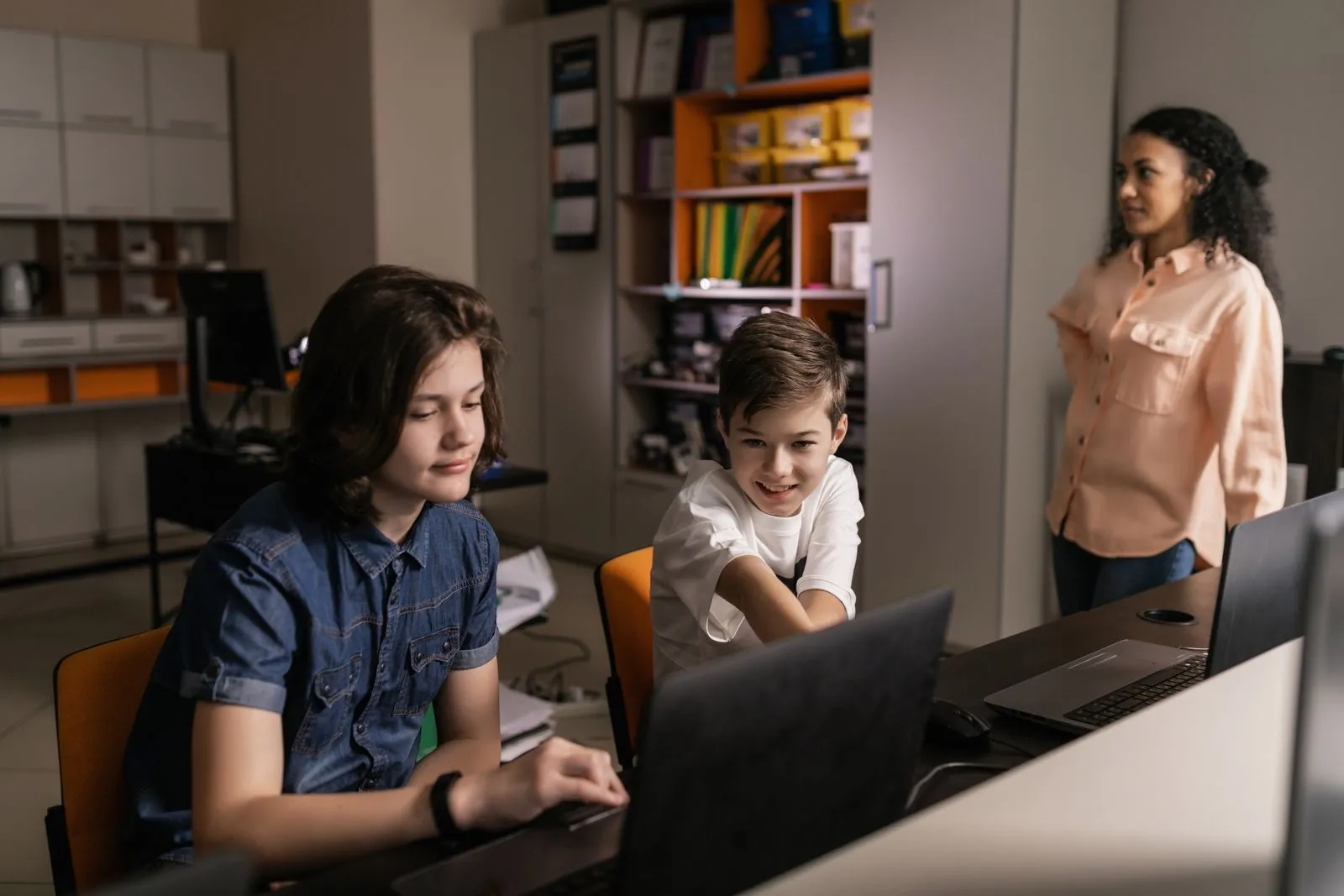 Students learning on laptops in a classroom