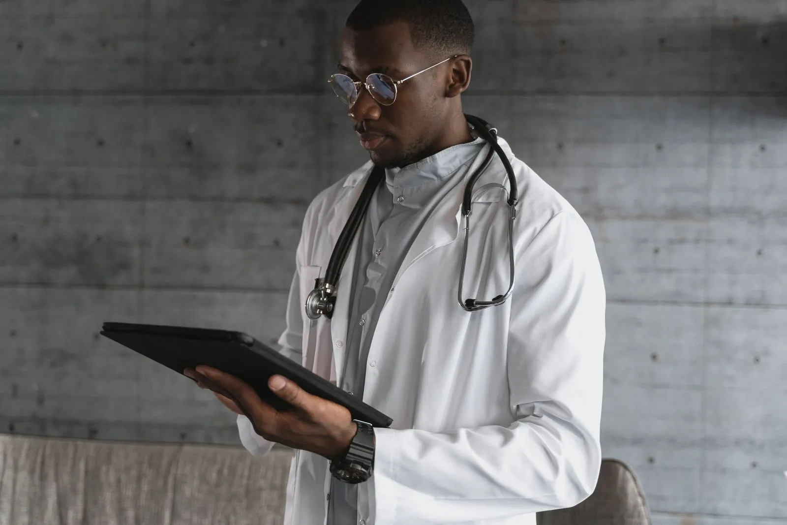 Clinician reviewing records on a digital tablet