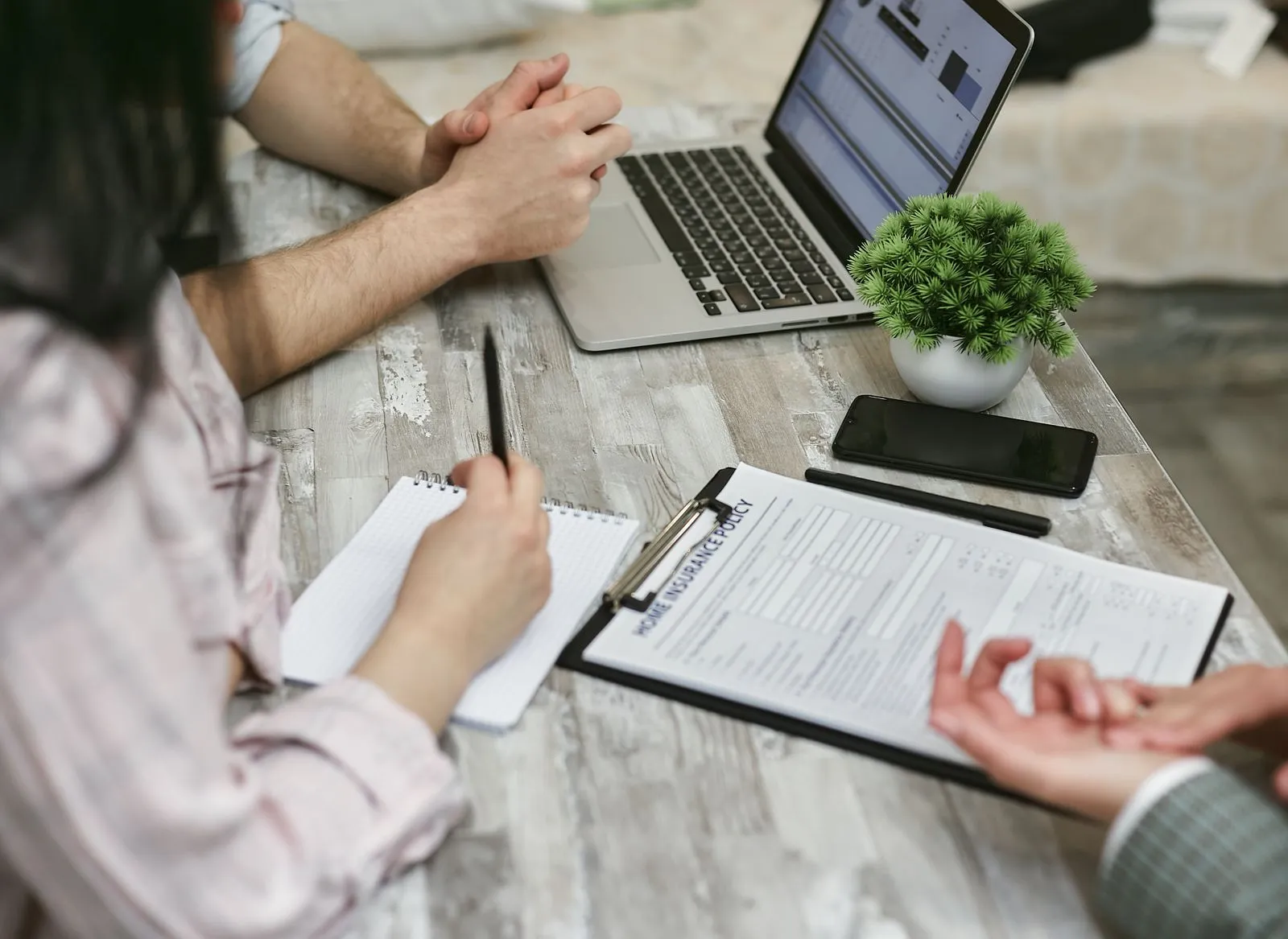 Advisor reviewing a policy with clients across a desk