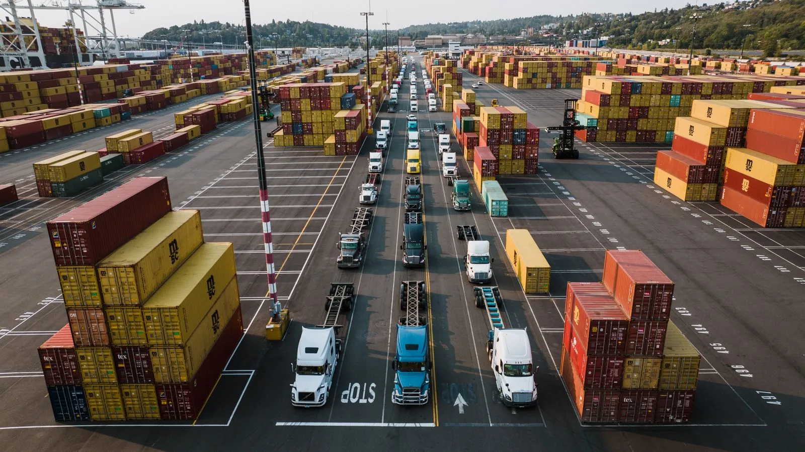 Freight trucks and shipping containers at a port