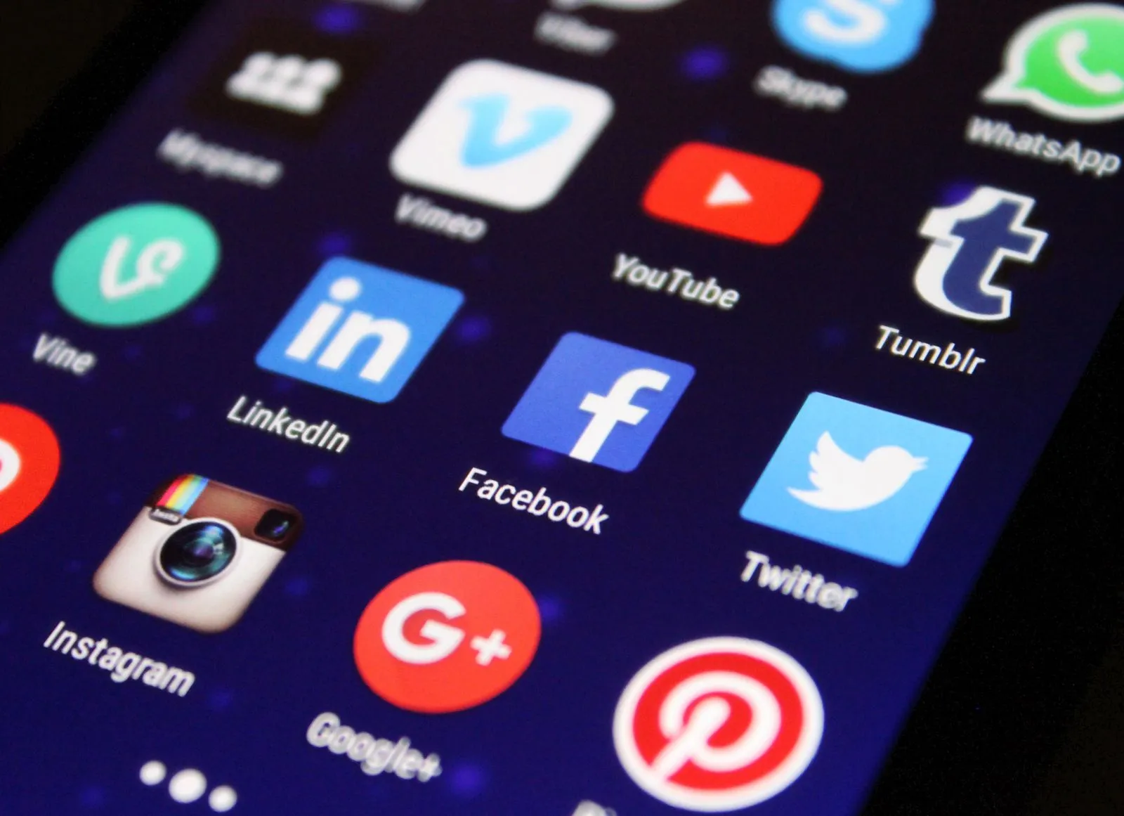 Extreme close-up of a phone's home screen showing LinkedIn, Facebook, Instagram, and other app icons